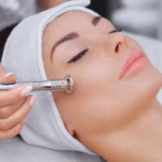 The,Cosmetologist,Makes,The,Procedure,Microdermabrasion,Of,The,Facial,Skin The cosmetologist makes the procedure Microdermabrasion of the facial skin of a beautiful, young woman in a beauty salon.Cosmetology and professional skin care.